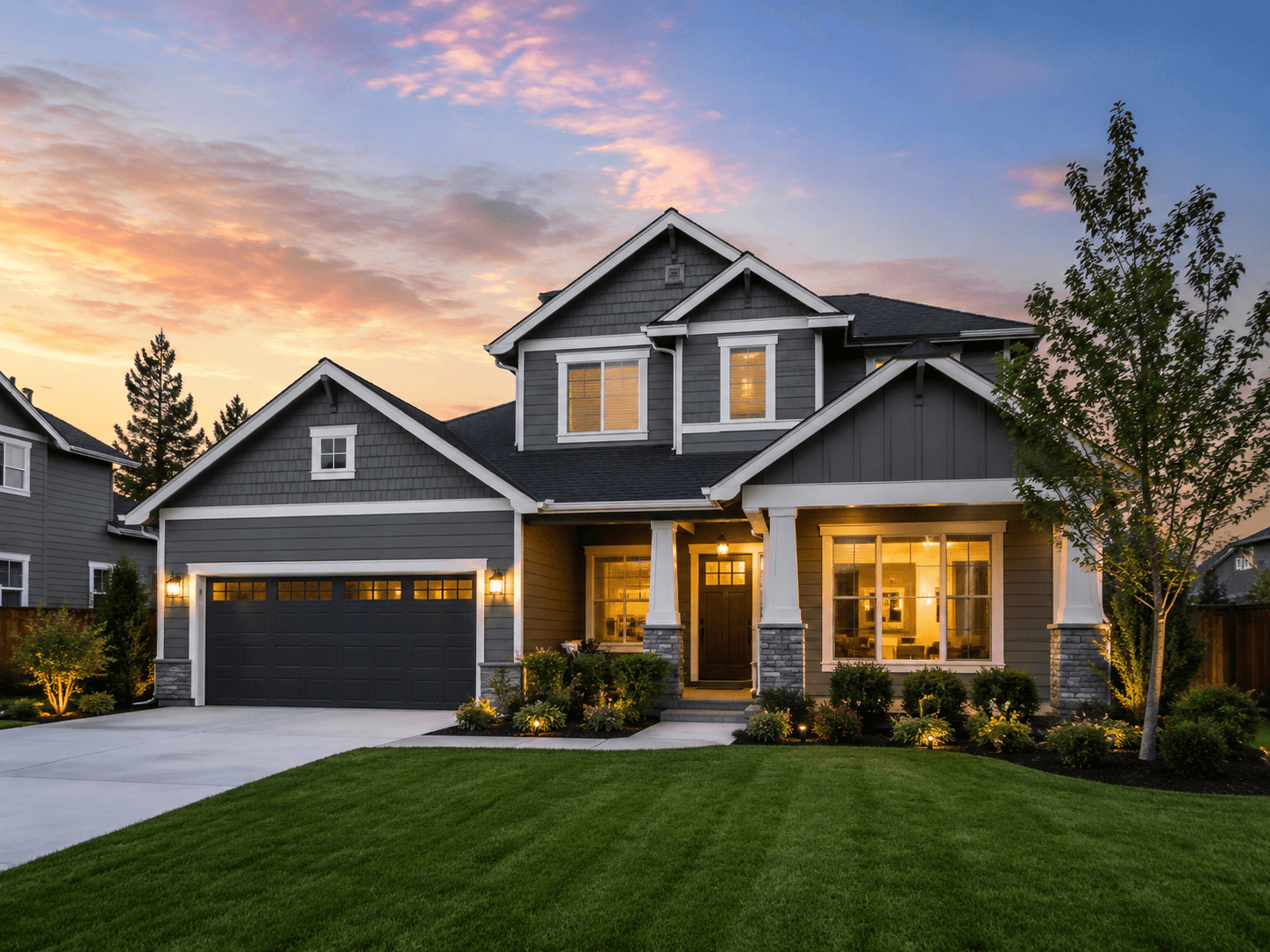 A modern two-storey home exterior at dusk
