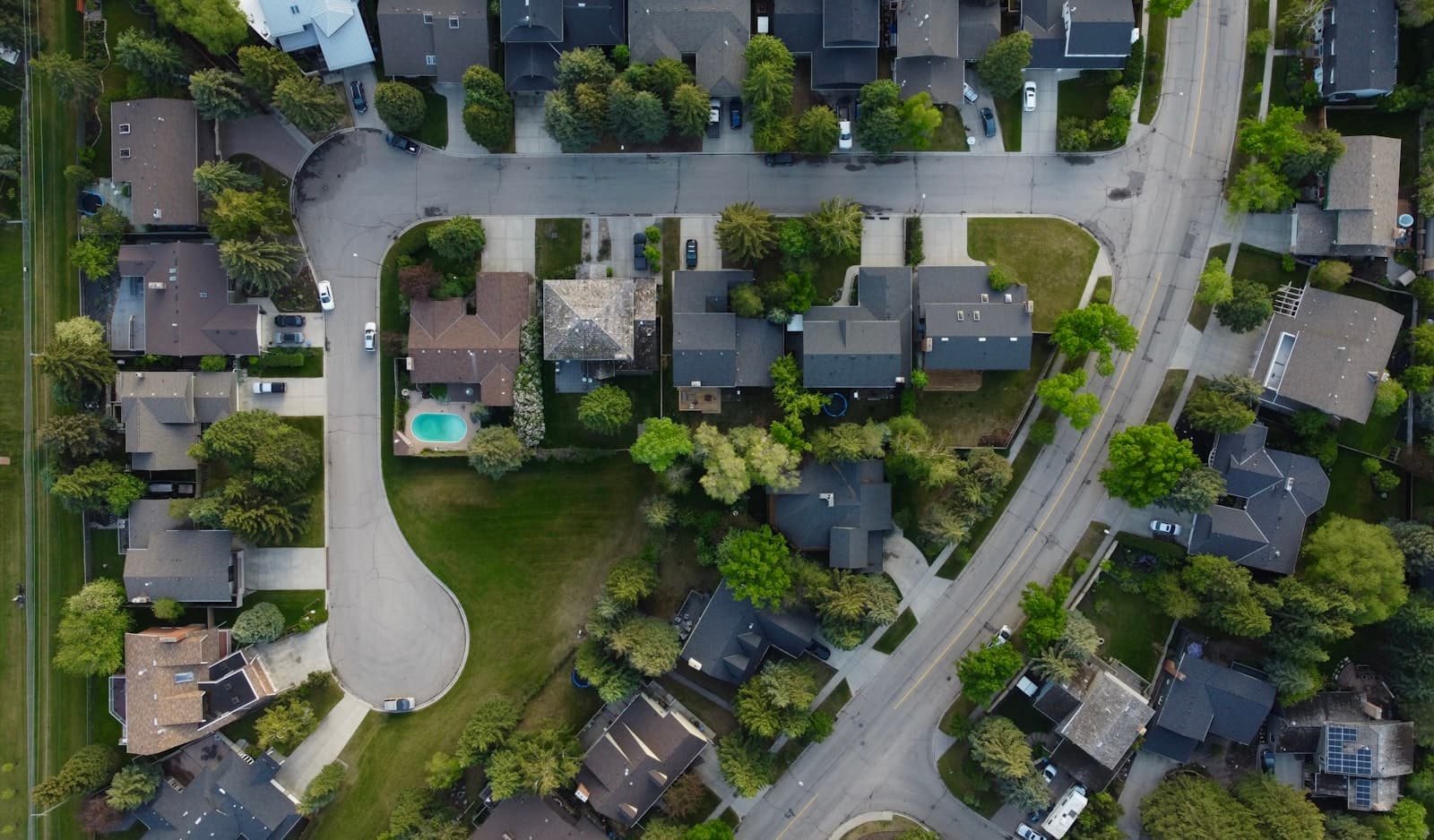 An aerial view of a residential street lined with houses